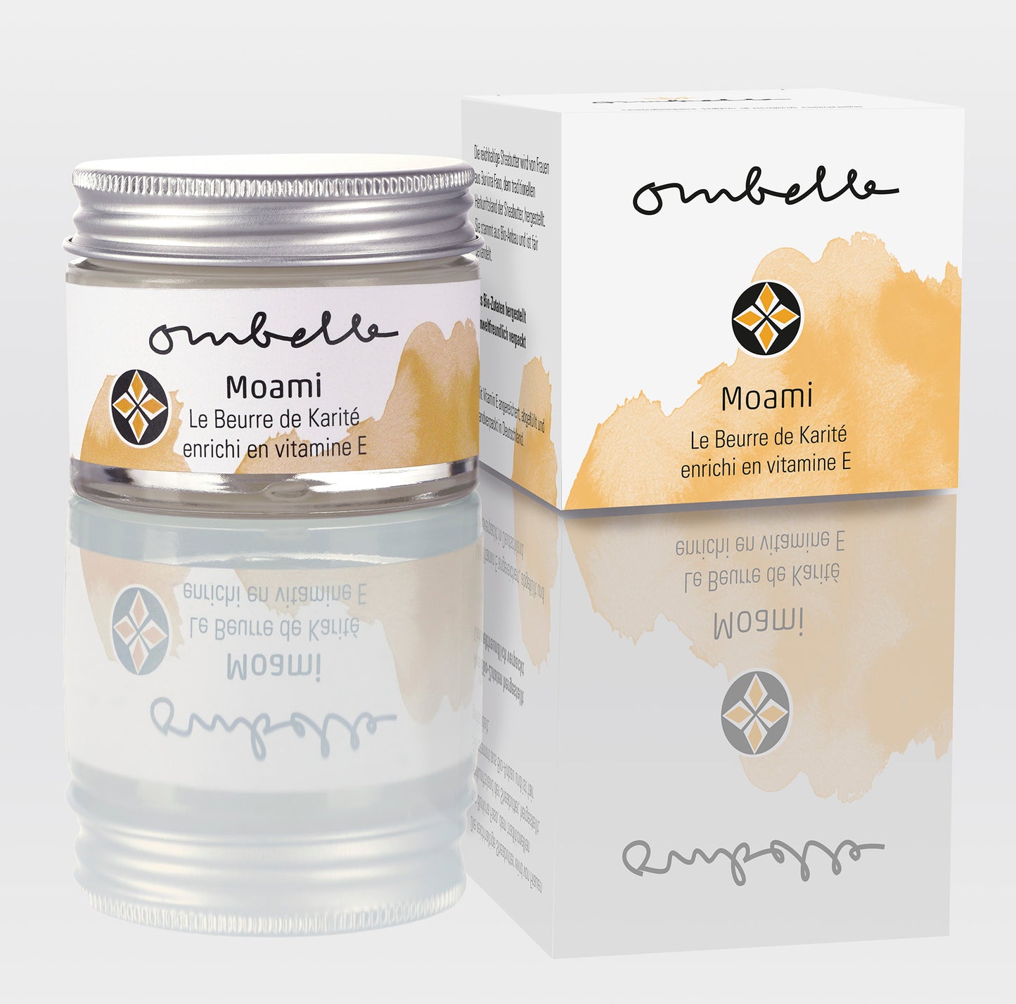 Ombelle Moami Bio Sheabutter 35ml, mit Vitamin E angereichert und aus einem Fair for Life Projekt: www.sotokacc.com. Daneben ist das Foto von dem Faltschachtel.